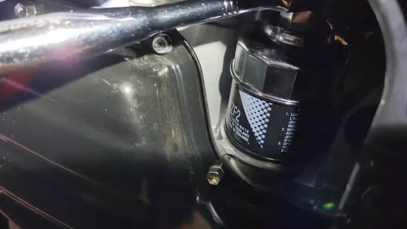 remove old oil filter with tool
