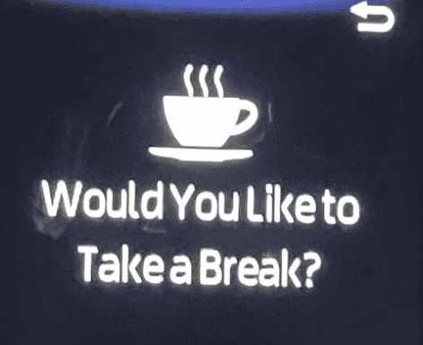 Toyota coffee cup light and text that says Would you like to take a break?